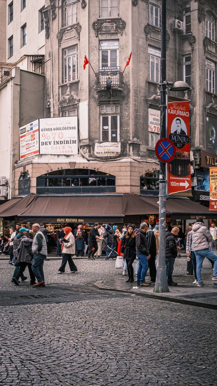 Crowded street view in İstanbul, showcasing historical architecture and vibrant daily life.